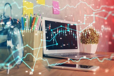 Financial graph colorful drawing and table with computer on background. Multi exposure. Concept of international markets.の写真素材