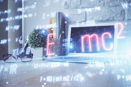 Desktop computer background and formula hologram writing. Double exposure. Education concept.の写真素材