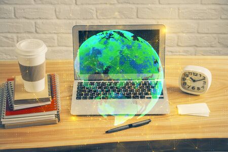 Computer on desktop with social network theme icon. Multi exposure. Concept of international connections.の写真素材