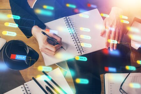 Double exposure of writing hands on background with data solution hologram on front. Technology concept. Close upの写真素材