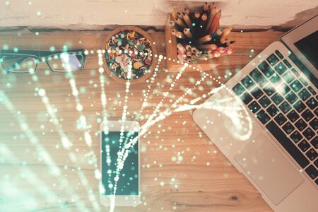 Double exposure of DNA drawing over table with phone. Top view. Science education concept.の写真素材