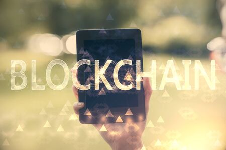 Double exposure of blockchain business sketch hologram and woman holding and using a mobile device.の写真素材