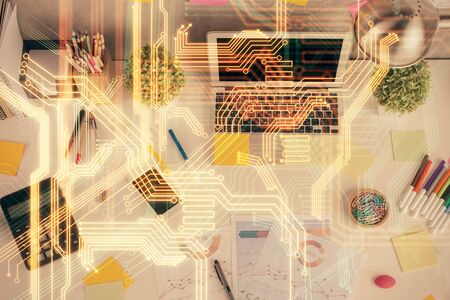 Technology hologram drawing over computer on the desktop background. Top view. Double exposure. Tech concept.の写真素材