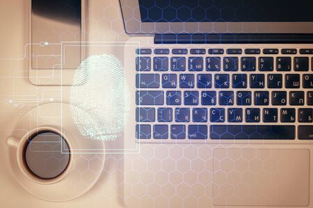 Finger print over computer on the desktop background. Top view. Double exposure. Concept of securitization.の写真素材