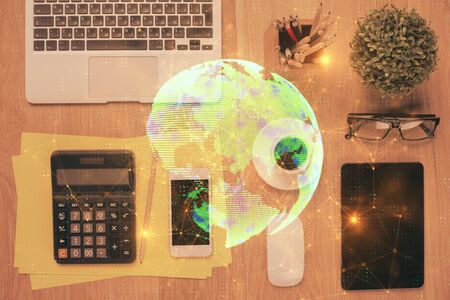 Double exposure of social network theme drawing over table with phone. Top view. People connecting concept.の写真素材