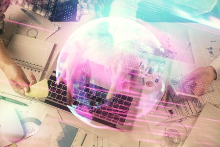 Double exposure of man and woman working together and technology theme drawing. Computer background. Top View. High tech concept.の写真素材