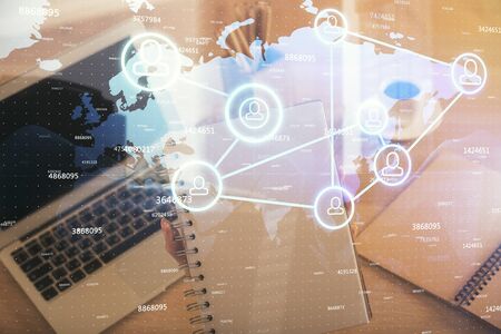 Double exposure of woman hands typing on computer and social network theme hologram drawing. People media concept.の写真素材