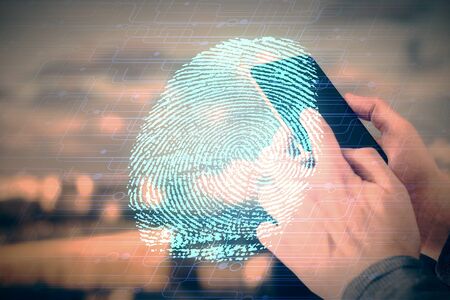 Double exposure of man's hands holding and using a digital device and fingerprint hologram drawing....