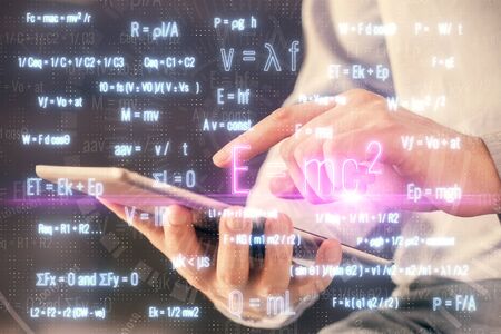 Double exposure of man's hands holding and using a phone and formulas drawing. Education concept.