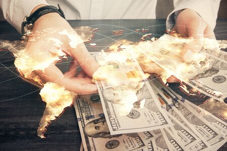 Multi exposure of financial theme drawing hologram and USA dollars bills and man hands. Business concept.の写真素材