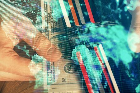 Multi exposure of financial theme drawing hologram and USA dollars bills and man hands. Business concept.の写真素材