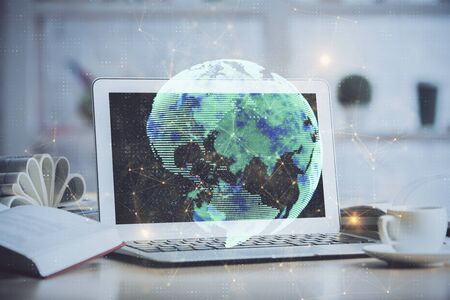 Computer on desktop with social network hologram. Multi exposure. Concept of international people connections.の写真素材