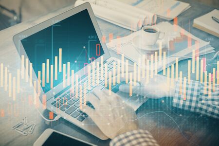 Double exposure of forex graph with man working on computer on background. Concept of market analysis.の写真素材