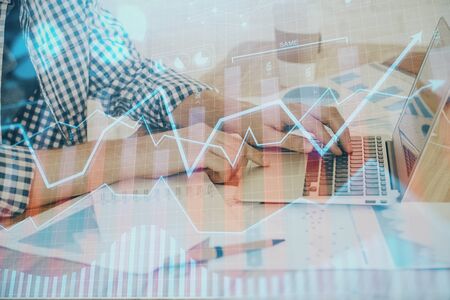 Multi exposure of stock market chart with man working on computer on background. Concept of financial analysis.の写真素材