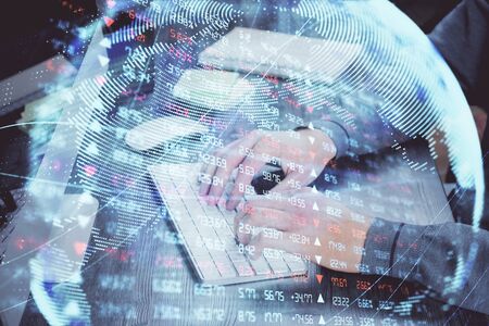 Double exposure of businessman working on laptop on background. International business hologram in front. Concept of success.の写真素材