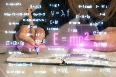 Double exposure of woman hands typing on computer and formula hologram drawing. Education concept.