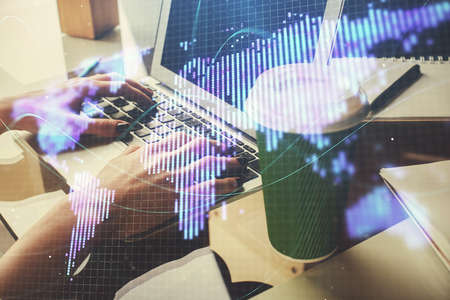 Double exposure of woman hands typing on computer and business theme hologram drawing. Success...