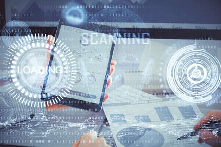 Double exposure of man's hand holding and using a digital device and data theme hologram drawing....