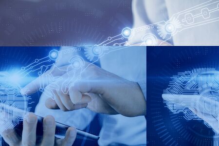 Double exposure of man's hand holding and using a digital device and brain hologram drawing. Data...