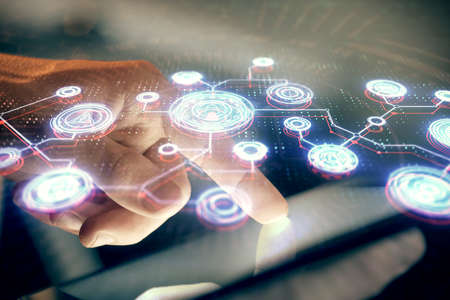 Double exposure of mans hands holding and using a phone and social network theme drawing.