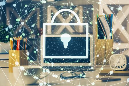Double exposure of desktop with computer and lock icon hologram. Concept of data safety.の写真素材