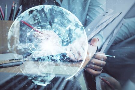 International business hologram over hands taking notes background. Concept of success. Multi exposureの写真素材