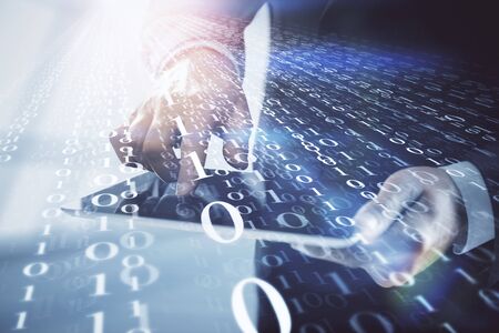 Double exposure of man's hand holding and using a digital device and data theme hologram drawing....