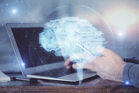 Double exposure of mans hand holding and using a digital device and brain hologram drawing. Data concept.の写真素材