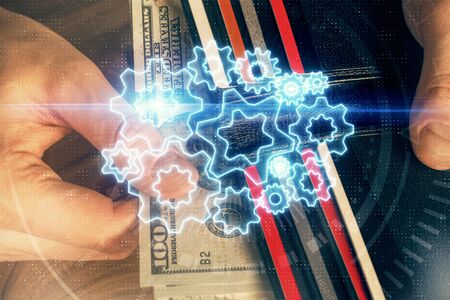 Multi exposure of financial theme drawing hologram and USA dollars bills and man hands. Business...