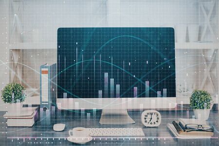 Forex graph hologram on table with computer background. Double exposure. Concept of financial markets.の写真素材