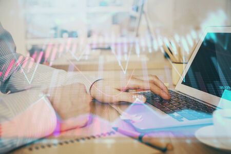 Multi exposure of stock market chart with man working on computer on background. Concept of...