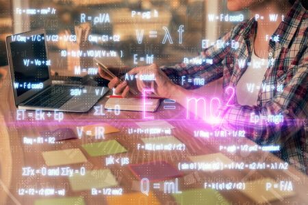 Double exposure of woman hands typing on computer and formula hologram drawing. Education concept.