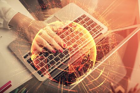 Double exposure of woman hands typing on computer and social network theme hologram drawing. People...