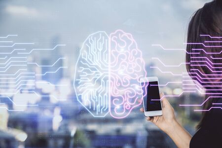 Double exposure of brain sketch hologram and woman holding and using a mobile device.の写真素材