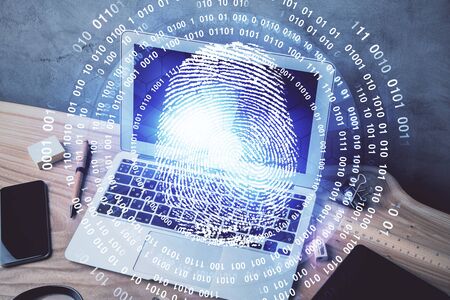 Computer on desktop in office with finger print drawing. Double exposure. Concept of business data...