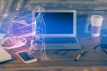 Desktop computer background in office and start up theme hologram drawing. Double exposure. Startup concept.の写真素材