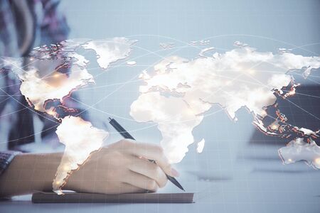 International business hologram over hands taking notes background. Concept of success. Multi exposureの写真素材