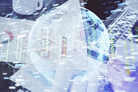 Double exposure of businessman working on laptop on background. International business hologram in...