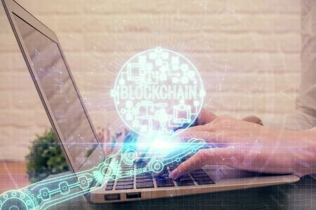 Double exposure of woman hands typing on computer and crypto market theme hologram drawing....