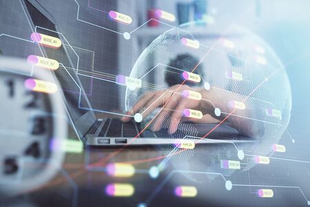 Double exposure of woman hands working on computer and world map hologram drawing. International...