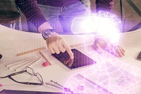 Double exposure of mans hands holding and using a digital device and AR glasses drawing. Virtual...