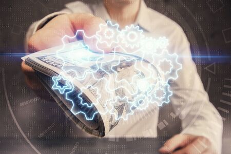 Multi exposure of financial theme drawing hologram and USA dollars bills and man hands. Business...