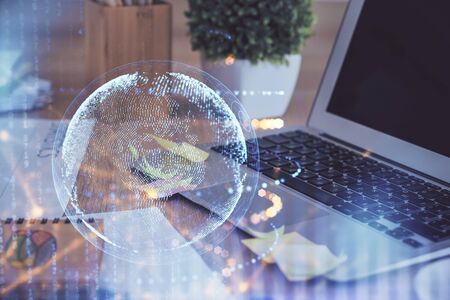 Multi exposure of table with computer and world map hologram. International data network concept.の写真素材