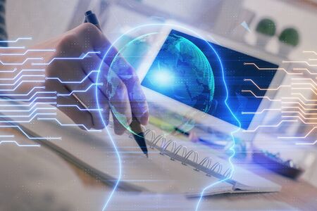 Multi exposure of writing hand on background with brain hologram. Concept of self learning.の写真素材
