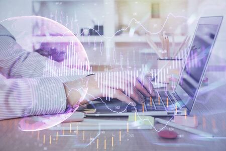 Double exposure of stock market graph with man working on laptop on background. Concept of financial analysis.の写真素材