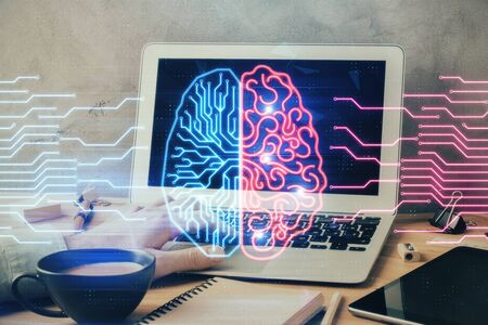 Businessman with computer background with brain theme hologram. Concept of brainstorm. Multi...