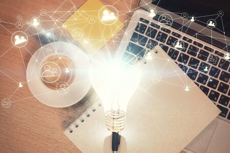 Bulb drawing over computer on the desktop background. Top view. Double exposure. Idea concept.の写真素材