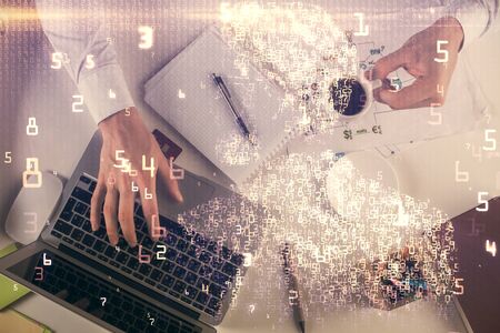 Double exposure of man's hands typing over computer keyboard and tech theme hologram drawing. Top...