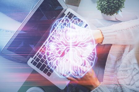 Double exposure of woman working on computer andhuman brain hologram drawing. Top View. Ai concept.