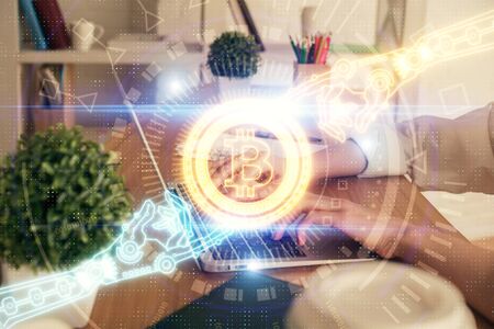 Double exposure of woman hands typing on computer and crypto market theme hologram drawing....